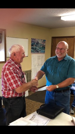Ron Globke of Marion presents Charlie Groen with a check for $5000. (Photo/submitted)